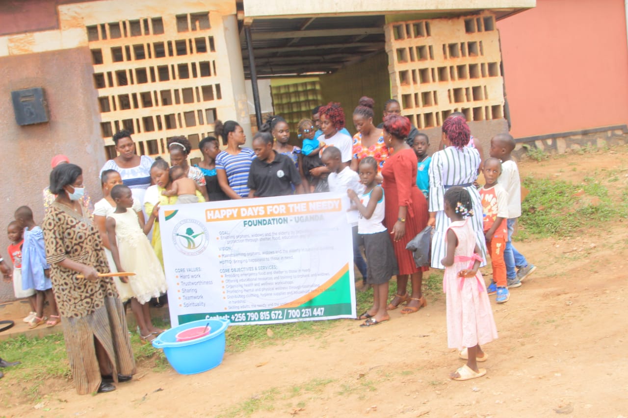 A community gathered around the foundation banner outdoors