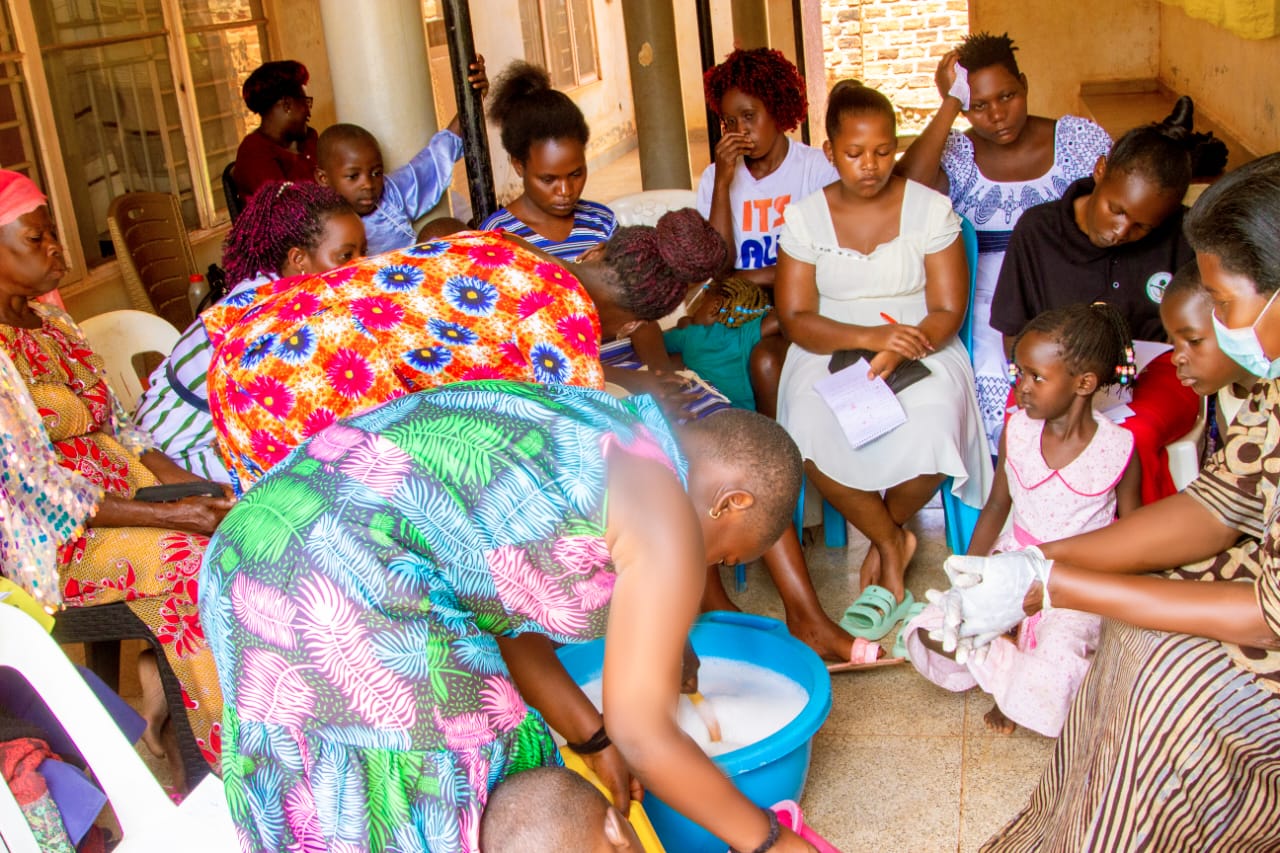 Participants gathered closely around a basin during training