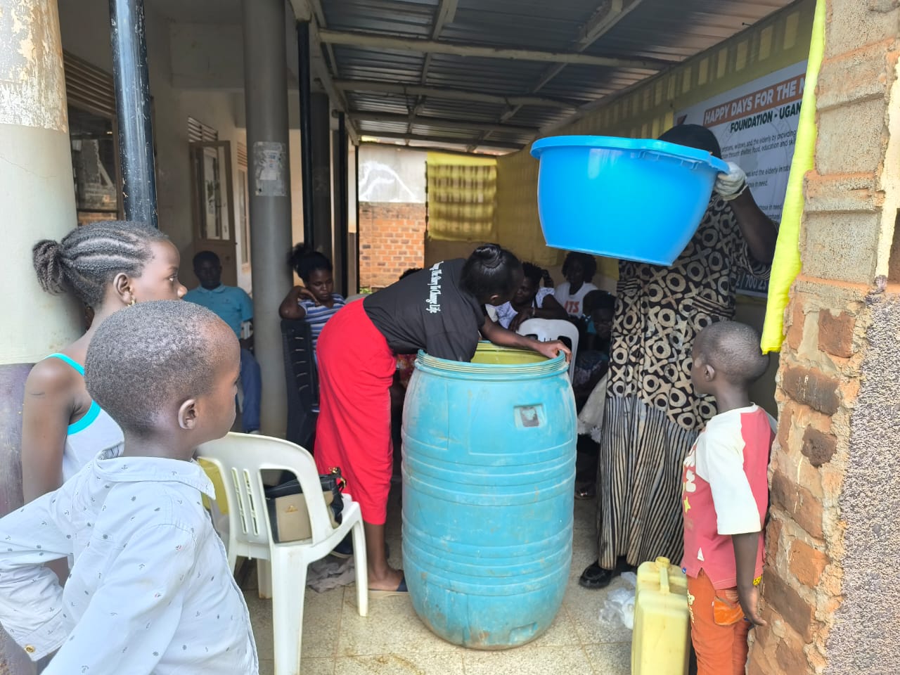 A facilitator lifting a basin during preparations for a workshop