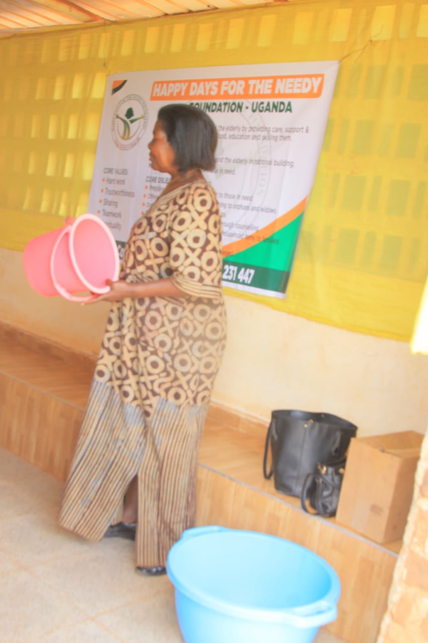 A facilitator carrying equipment past the foundation banner