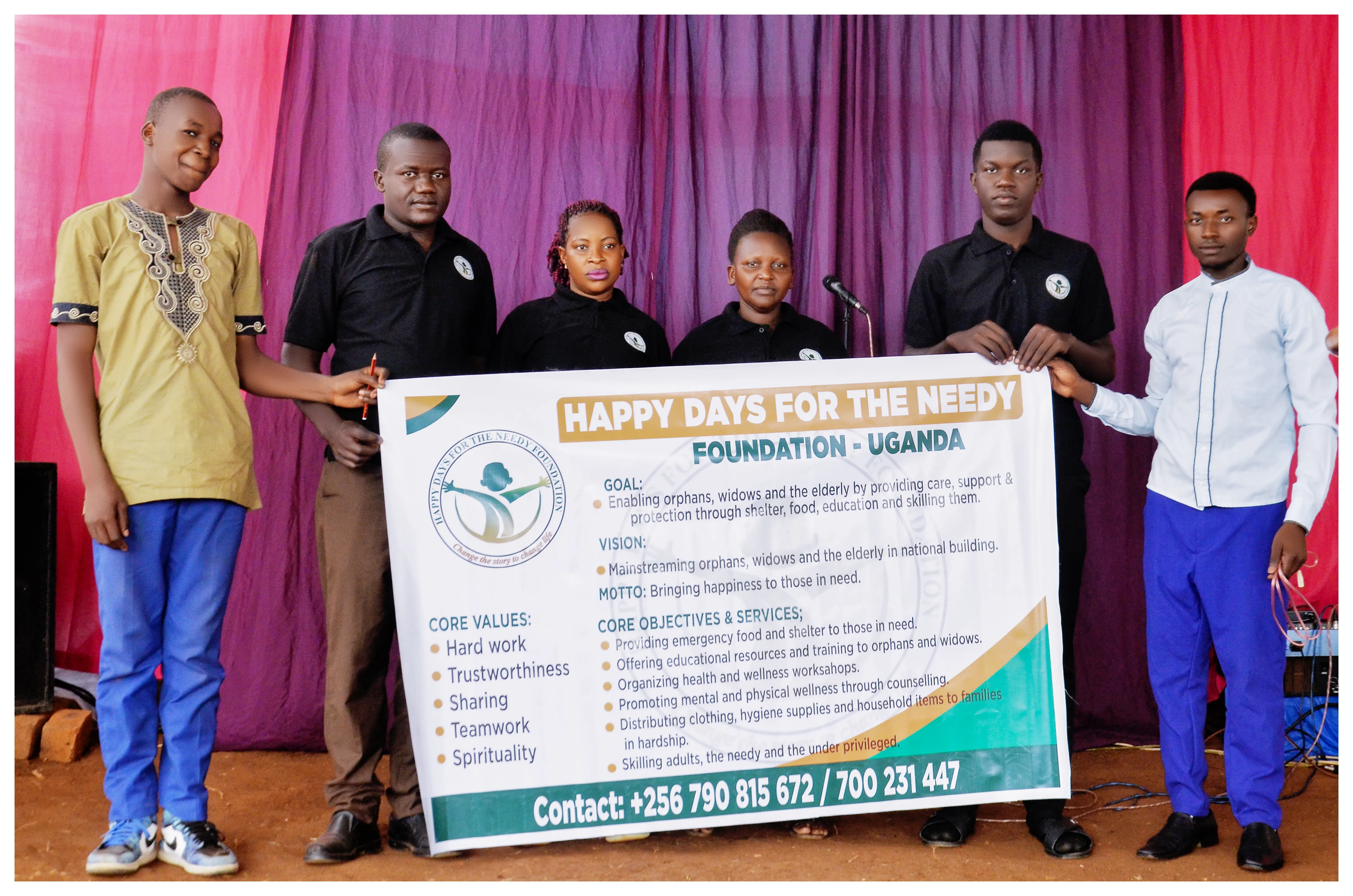 The team holding the foundation banner